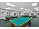 Well-lit billiards room with multiple pool tables at 4928 Kelso St, Leesburg, FL 34748