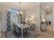 Charming dining room with white table and blue patterned chairs at 4928 Kelso St, Leesburg, FL 34748