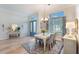 Bright dining room with hardwood floors and elegant light fixture at 4928 Kelso St, Leesburg, FL 34748