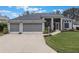 Attractive one-story home with a three-car garage and well-manicured lawn at 4928 Kelso St, Leesburg, FL 34748