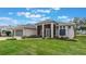 One story home with three-car garage, screened porch, and nicely landscaped yard at 4928 Kelso St, Leesburg, FL 34748