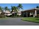 Community clubhouse with palm trees and circular driveway at 4928 Kelso St, Leesburg, FL 34748