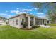 Single-story home with screened lanai and well-manicured lawn at 4928 Kelso St, Leesburg, FL 34748