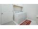 Laundry room with washer, dryer, and cabinet storage at 4928 Kelso St, Leesburg, FL 34748