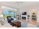 Living room with hardwood floors, fireplace, and sliding doors to patio at 4928 Kelso St, Leesburg, FL 34748