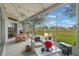 Sunroom with seating area, dining table, and view of the backyard at 4928 Kelso St, Leesburg, FL 34748