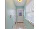 Light teal entryway with white door, tile floor and window with blinds at 500 Southern Charm Dr, Orlando, FL 32807