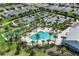 Aerial view showing community pool, tennis courts, and bocce ball at 5278 Dragonfly Dr, Wildwood, FL 34785