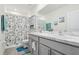 Main bathroom with double vanity and shower/tub combo at 5278 Dragonfly Dr, Wildwood, FL 34785