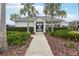 Community clubhouse with landscaping and palm trees at 5278 Dragonfly Dr, Wildwood, FL 34785