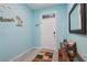 Bright entryway with light blue walls, tile floor, and console table at 5278 Dragonfly Dr, Wildwood, FL 34785