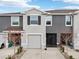 Two-story townhome with gray exterior, attached garage, and screened porch at 5278 Dragonfly Dr, Wildwood, FL 34785