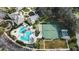 Community pool, tennis courts, and clubhouse viewed from above at 5318 Fantasy Way, Leesburg, FL 34748