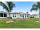 Backyard view showing a house with well-maintained lawn and palm trees at 5318 Fantasy Way, Leesburg, FL 34748