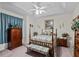 Bedroom with a wooden post bed and ceiling fan at 5318 Fantasy Way, Leesburg, FL 34748