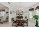 Elegant dining room with chandelier and glass-top table at 5318 Fantasy Way, Leesburg, FL 34748