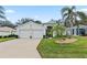 Two-car garage and manicured lawn at 5318 Fantasy Way, Leesburg, FL 34748