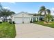 Two-car garage and manicured lawn at 5318 Fantasy Way, Leesburg, FL 34748