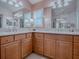 Bathroom with granite countertops and dual sinks at 581 Society Hill Cir, The Villages, FL 32162