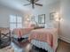 Bedroom with two twin beds, a ceiling fan, and hardwood floors at 581 Society Hill Cir, The Villages, FL 32162