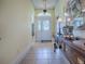 Bright entry hall with tiled floor, antique console table, and access to other rooms at 581 Society Hill Cir, The Villages, FL 32162