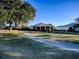 This property boasts a screened-in porch and lush landscaping at 581 Society Hill Cir, The Villages, FL 32162