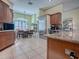 Spacious kitchen with stainless steel appliances and granite countertops at 581 Society Hill Cir, The Villages, FL 32162