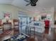 Bright living room featuring hardwood floors, comfy seating, and sliding glass doors to a patio at 581 Society Hill Cir, The Villages, FL 32162