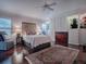 Main bedroom with a queen bed, built-in wardrobe, and hardwood floors at 581 Society Hill Cir, The Villages, FL 32162