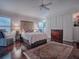 Main bedroom with a queen bed, built-in wardrobe, and hardwood floors at 581 Society Hill Cir, The Villages, FL 32162