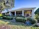 Relax on the large screened porch with beautiful landscaping at 581 Society Hill Cir, The Villages, FL 32162