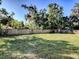 Large grassy backyard with wooden fence and trees at 808 E Orange St, Apopka, FL 32703