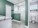 Spa-like bathroom with marble shower and green walls at 808 E Orange St, Apopka, FL 32703