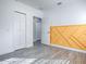 Bedroom with mustard geometric accent wall and gray floors at 808 E Orange St, Apopka, FL 32703