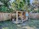 Wooden chicken coop with wire enclosure in the backyard at 808 E Orange St, Apopka, FL 32703