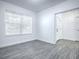 Bright entryway with white door and gray wood-look floors at 808 E Orange St, Apopka, FL 32703