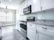 Modern kitchen with white shaker cabinets and granite countertop at 808 E Orange St, Apopka, FL 32703