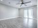 Bright living room with sliding glass doors and ceiling fan at 808 E Orange St, Apopka, FL 32703