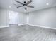 Spacious living room with ceiling fan and gray flooring at 808 E Orange St, Apopka, FL 32703