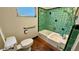 Bathroom with green tile and classic bathtub at 819 Edgewater Dr, Eustis, FL 32726