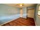 Light blue bedroom includes hardwood floors and closet at 819 Edgewater Dr, Eustis, FL 32726