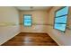 Bedroom with hardwood floors and two windows at 819 Edgewater Dr, Eustis, FL 32726