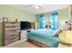 Charming bedroom with teal bedding and large window at 860 Evelynton Loop, The Villages, FL 32162