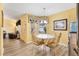 Dining area with glass table and chairs at 860 Evelynton Loop, The Villages, FL 32162