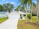 House exterior with driveway, landscaping, and garage at 860 Evelynton Loop, The Villages, FL 32162