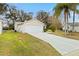 House exterior with driveway, landscaping, and garage at 860 Evelynton Loop, The Villages, FL 32162