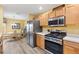 Bright kitchen with stainless steel appliances and light wood cabinets at 860 Evelynton Loop, The Villages, FL 32162