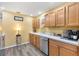 Kitchen with light wood cabinets and stainless steel appliances at 860 Evelynton Loop, The Villages, FL 32162