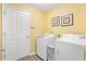 Laundry room with washer, dryer, and ample storage space at 860 Evelynton Loop, The Villages, FL 32162