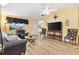 Living room with gray couch and laminate wood floor at 860 Evelynton Loop, The Villages, FL 32162